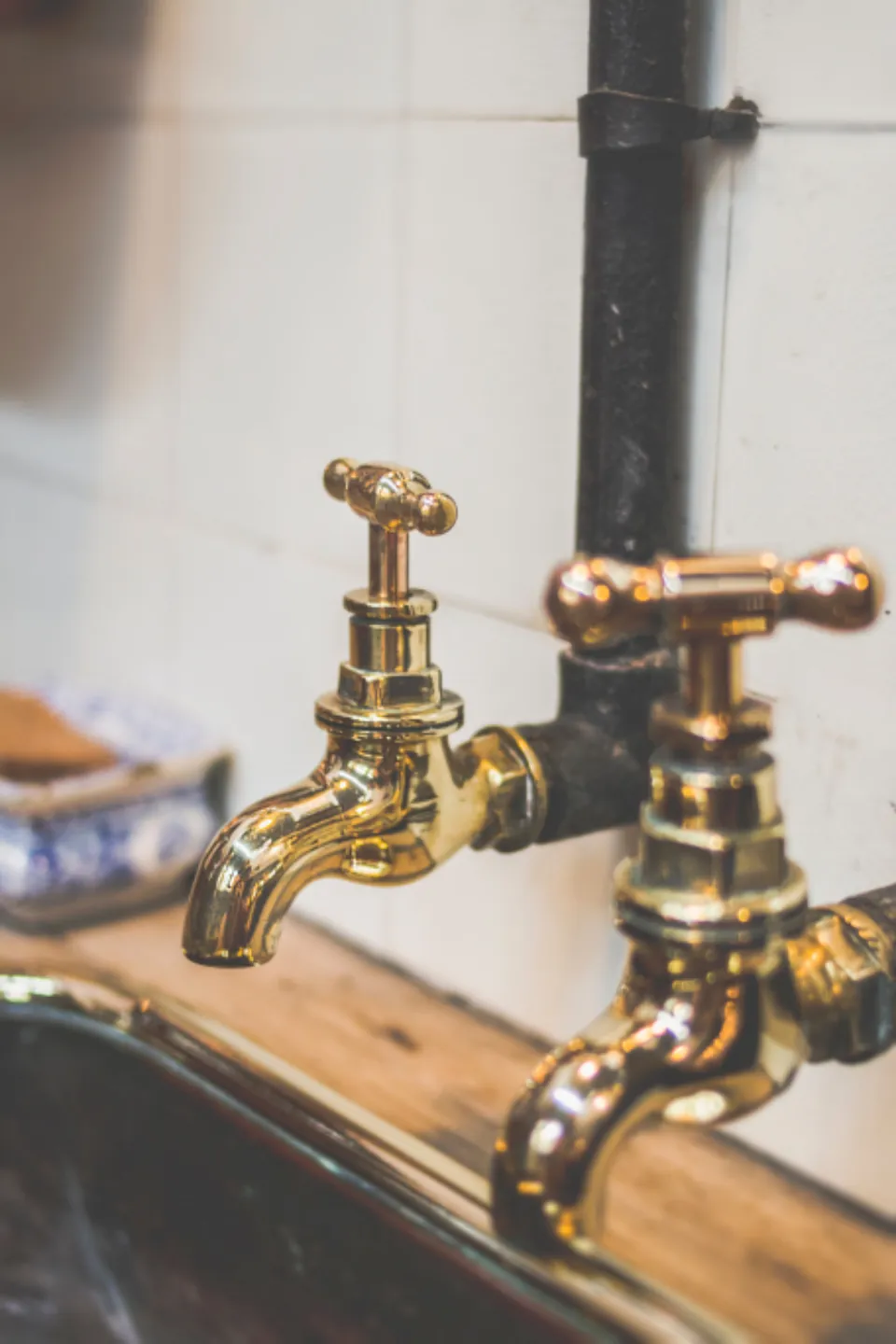 Old brass faucet taps over a sink