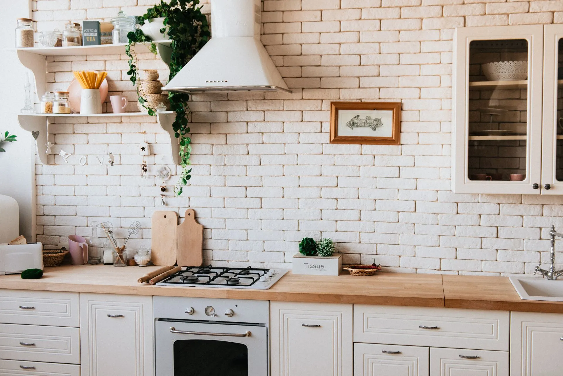 A white brick kitchen with open shelves