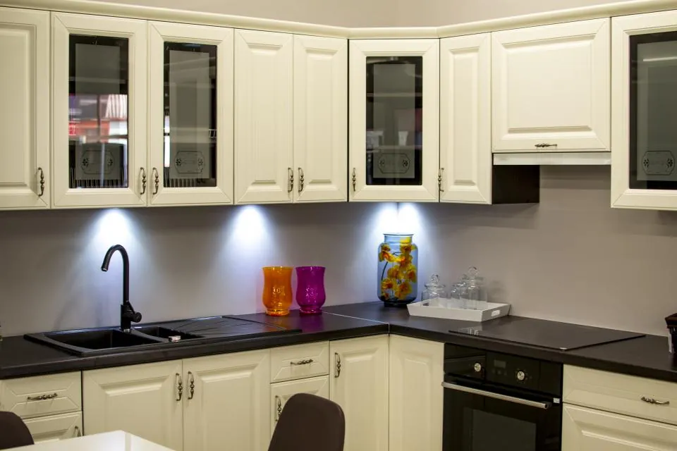 Cream kitchen cabinets with under-cabinet lighting