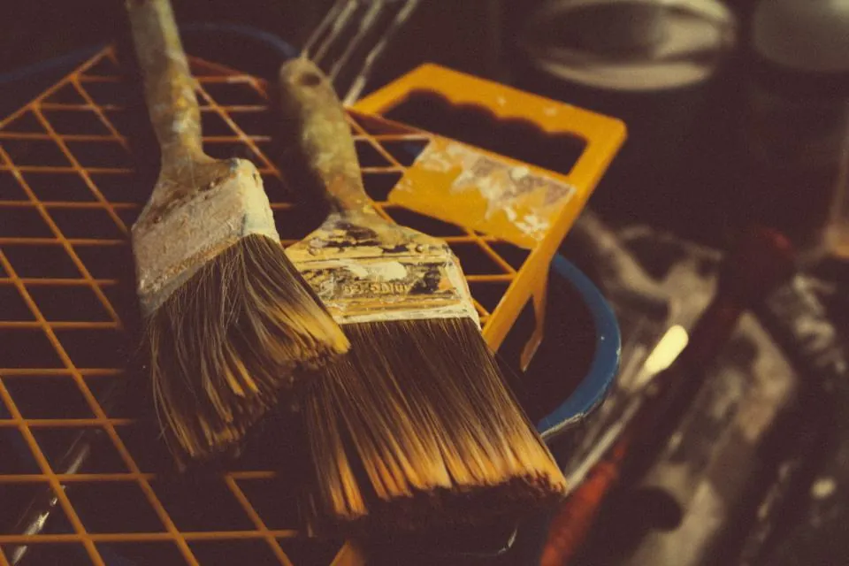 Worn paint brushes on a grid