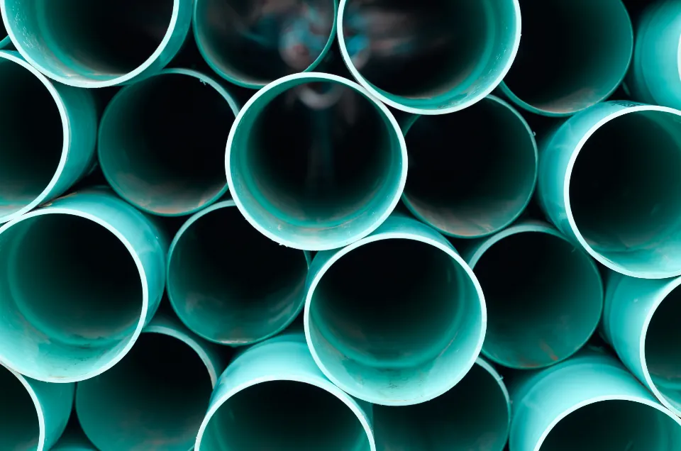 A stack of plastic drain pipes