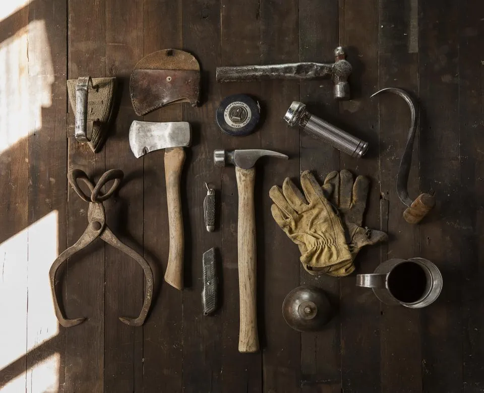 Hand tools laid out on a wooden table